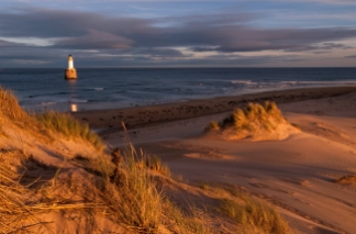 Rattray Point, is a headland in Buchan, Aberdeenshire, on the north-east coast of Scotland. The dunes at Rattray Head beach can be up to 75 feet (23 m) high and stretch 17 miles (27 km) from St Combs to Peterhead. The 120 feet (37 m) Lighthouse was built in 1895 by the engineering brothers Stevenson David Alan Stevenson and Charles Alexander Stevenson. In February 1982 it became unmanned and self-working.[2][3] The lighthouse is accessible by way of a causeway that is usually underwater being only visible at low tide. It is wide enough for a vehicle to cross. Remains of several shipwrecks can still be seen on the beach. (wikipedia)